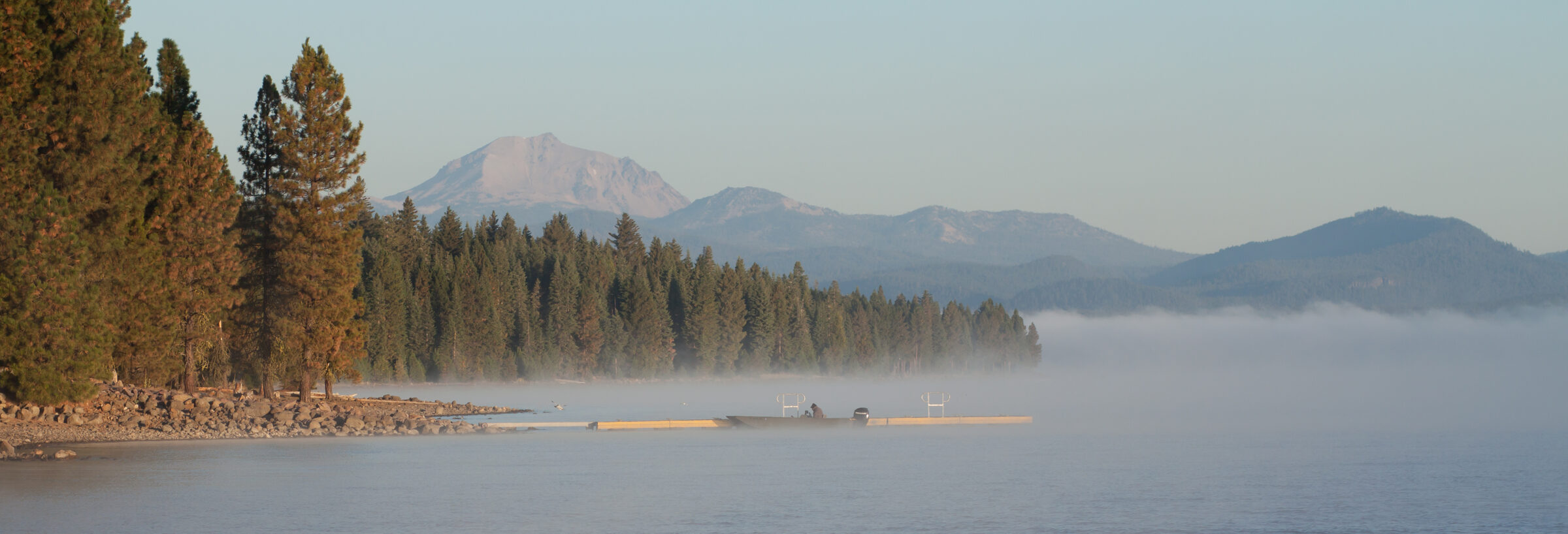 Early morning mist over Lake Almanor with Lassen Peak in the distance